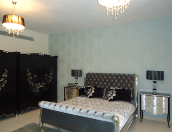 Luxury bedroom interior with tufted bed and mirrored bedside tables