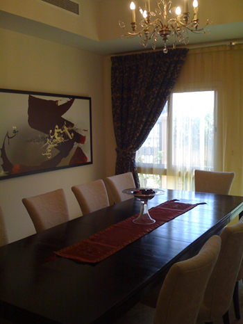 Elegant dining room close-up with chandelier and drapery