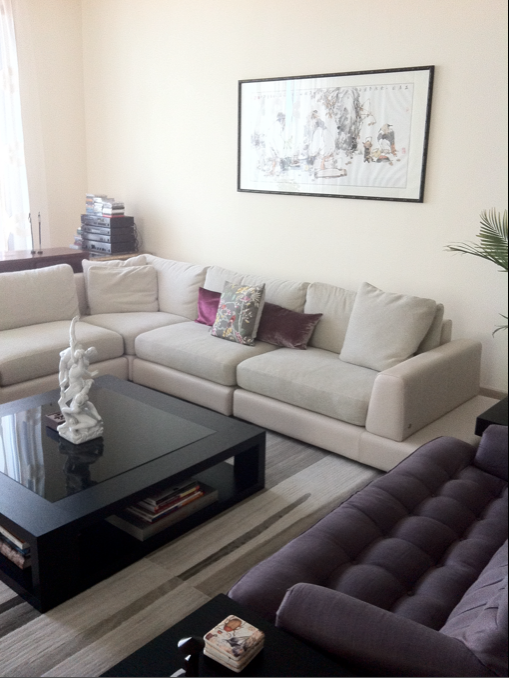 Villa family room with cream seating, flowers, and classic coffee table