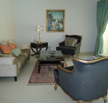 Classic living room interior design in Dubai with blue accent chairs and elegant coffee table